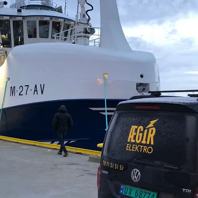 Svart bil med Ægir Elektro AS logo, og båt